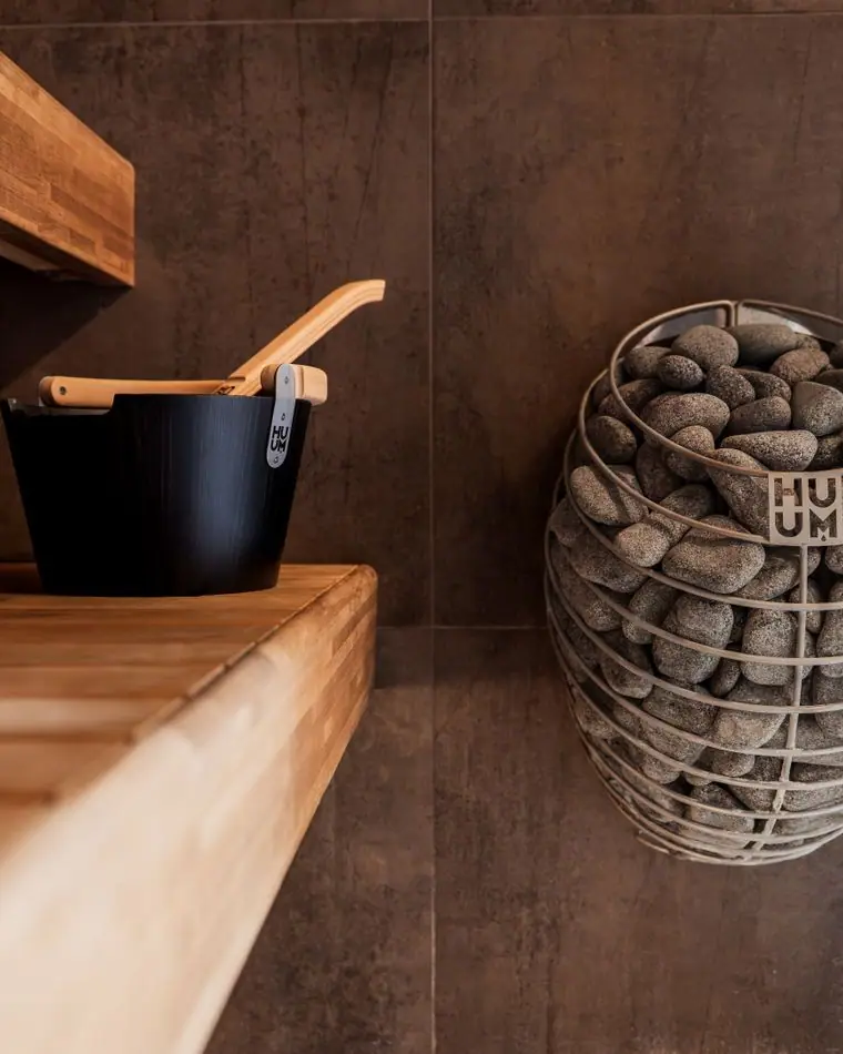A wooden Nordic sauna with a stone heater