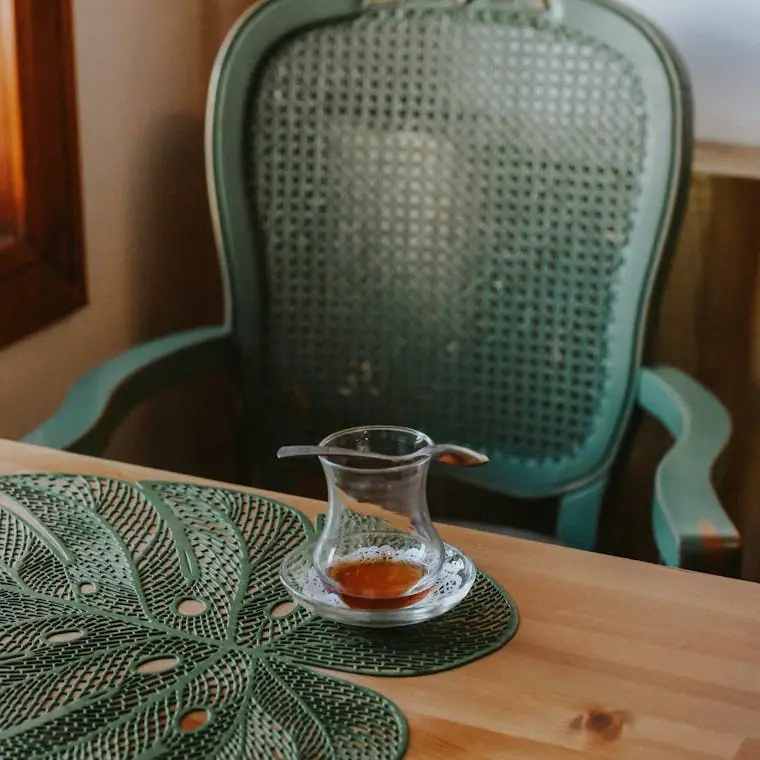 An elegant tea cup resting on a rustic wooden table