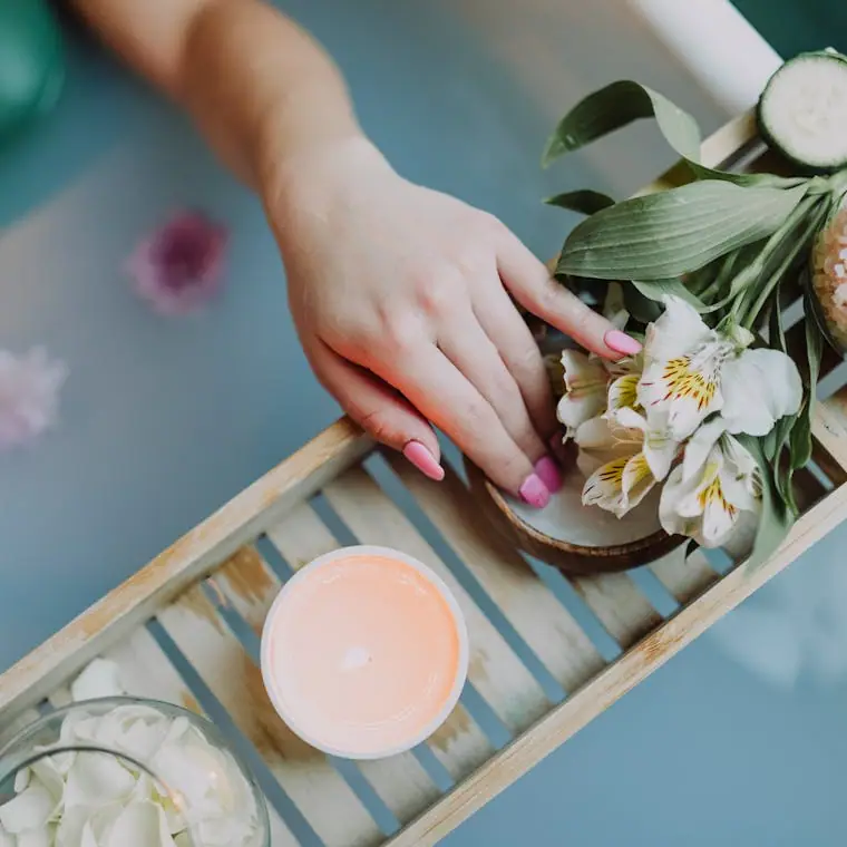 A flat-lay of spa botanicals, salts and candles